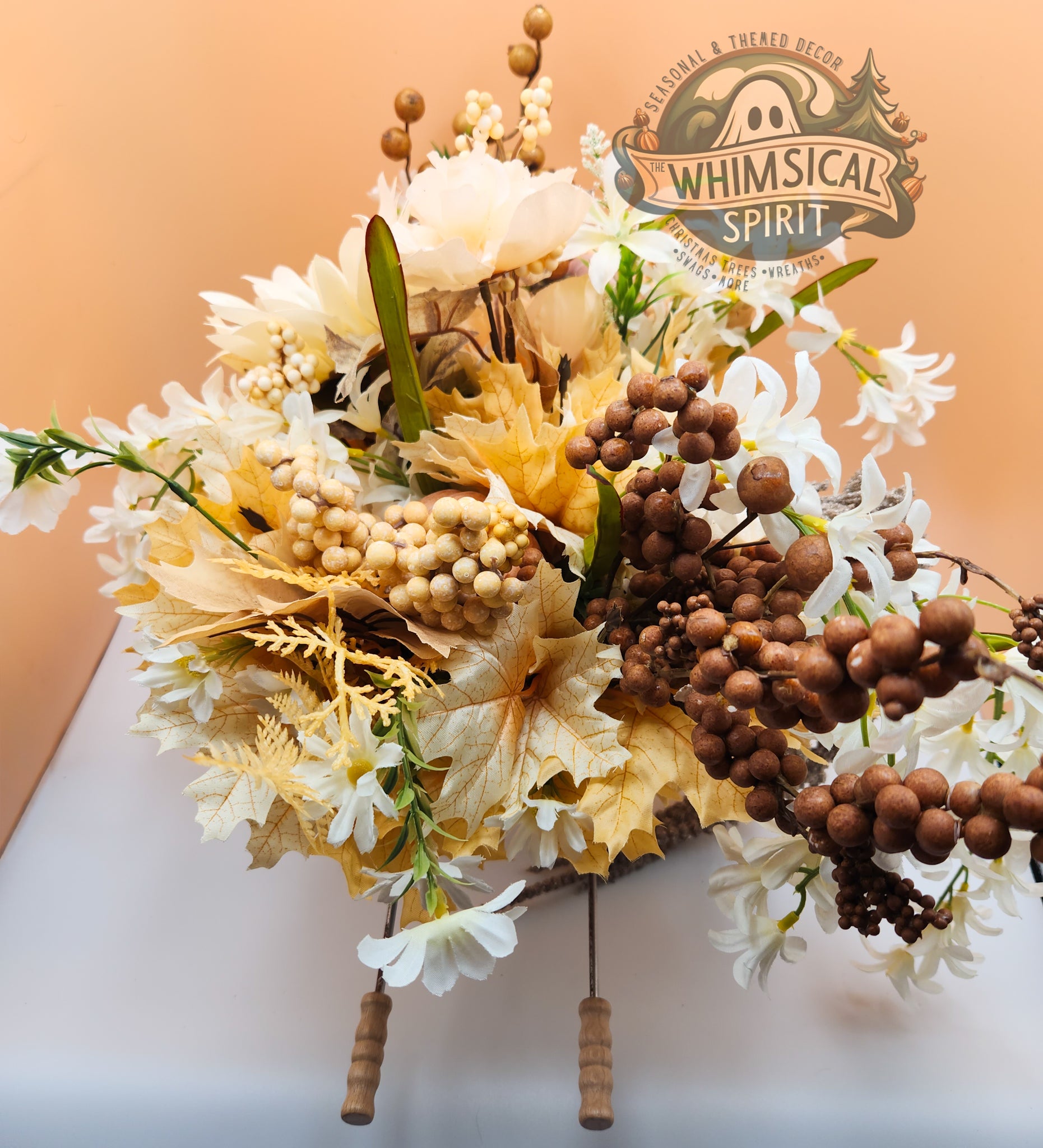 Decorative wreath with flowers and berries on a peach background, featuring 'Whimsical Spirit' logo.