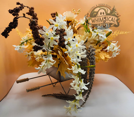 Decorative headband with flowers and leaves on a white surface, branded 'Whimsical Spirit'.