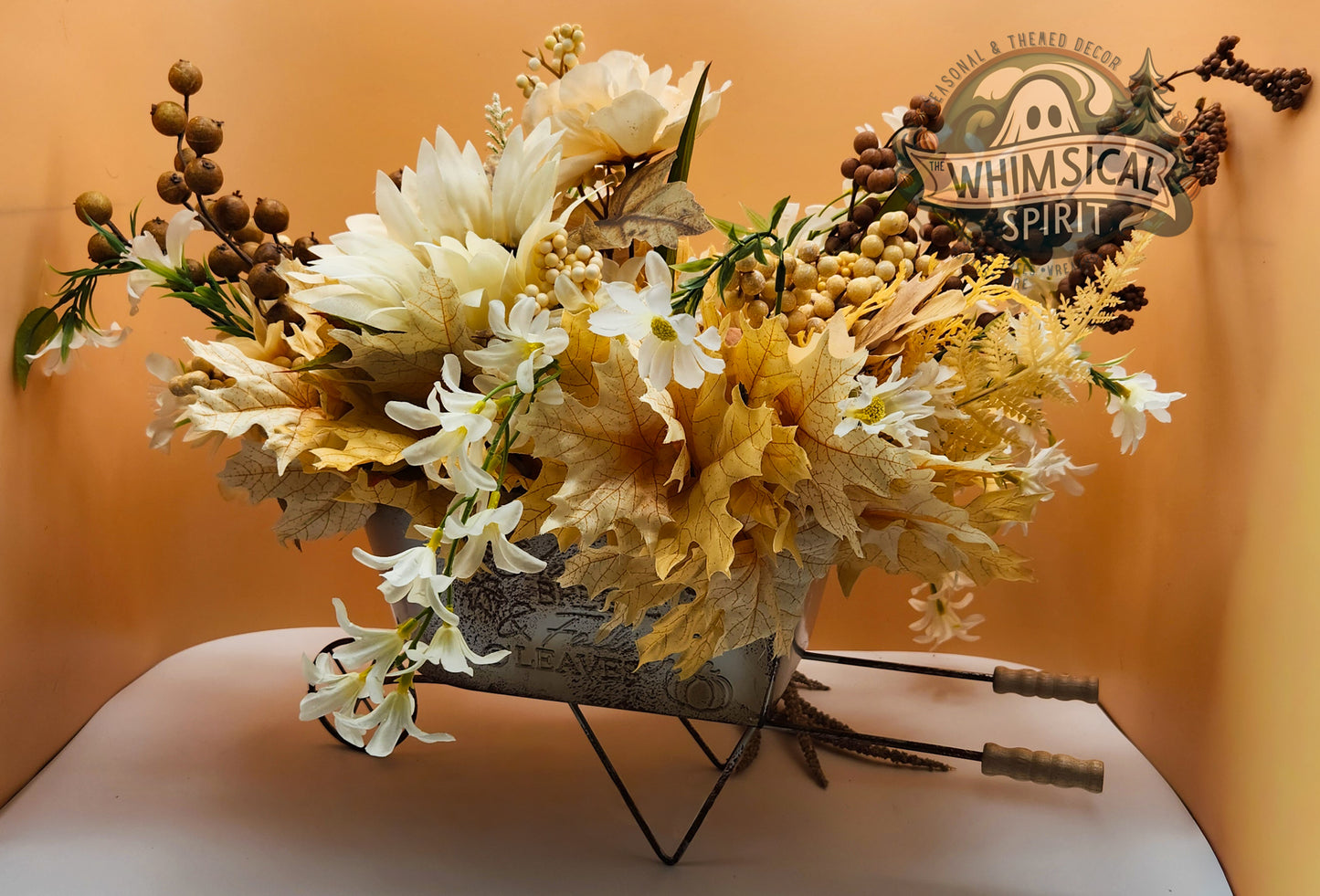 Floral arrangement in a metal container with 'Whimsical Spirit' branding on a yellow background