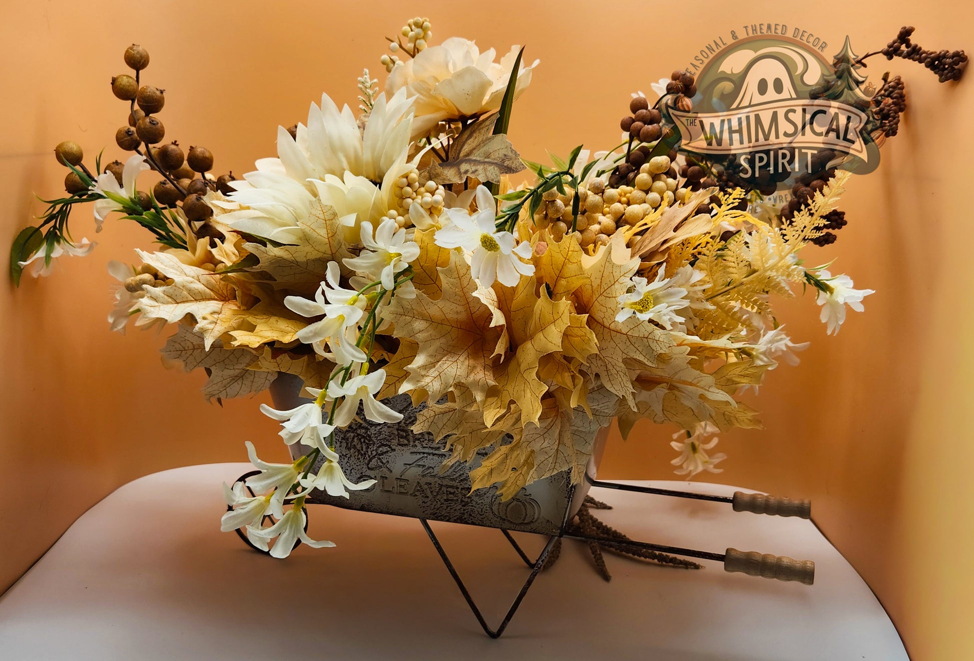 Floral arrangement in a metal container with 'Whimsical Spirit' branding on a yellow background