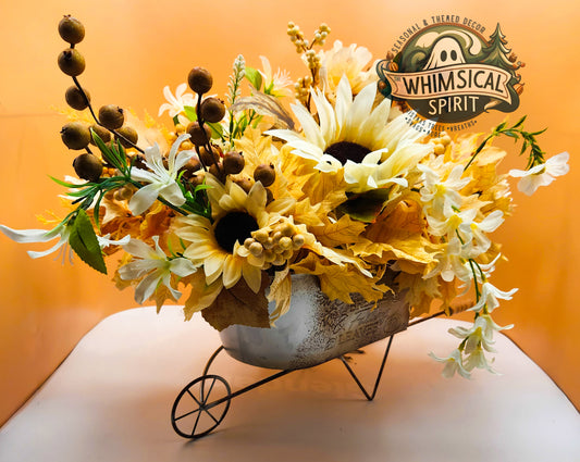 Floral arrangement in a decorative pot with 'Whimsical Spirit' branding on an orange background