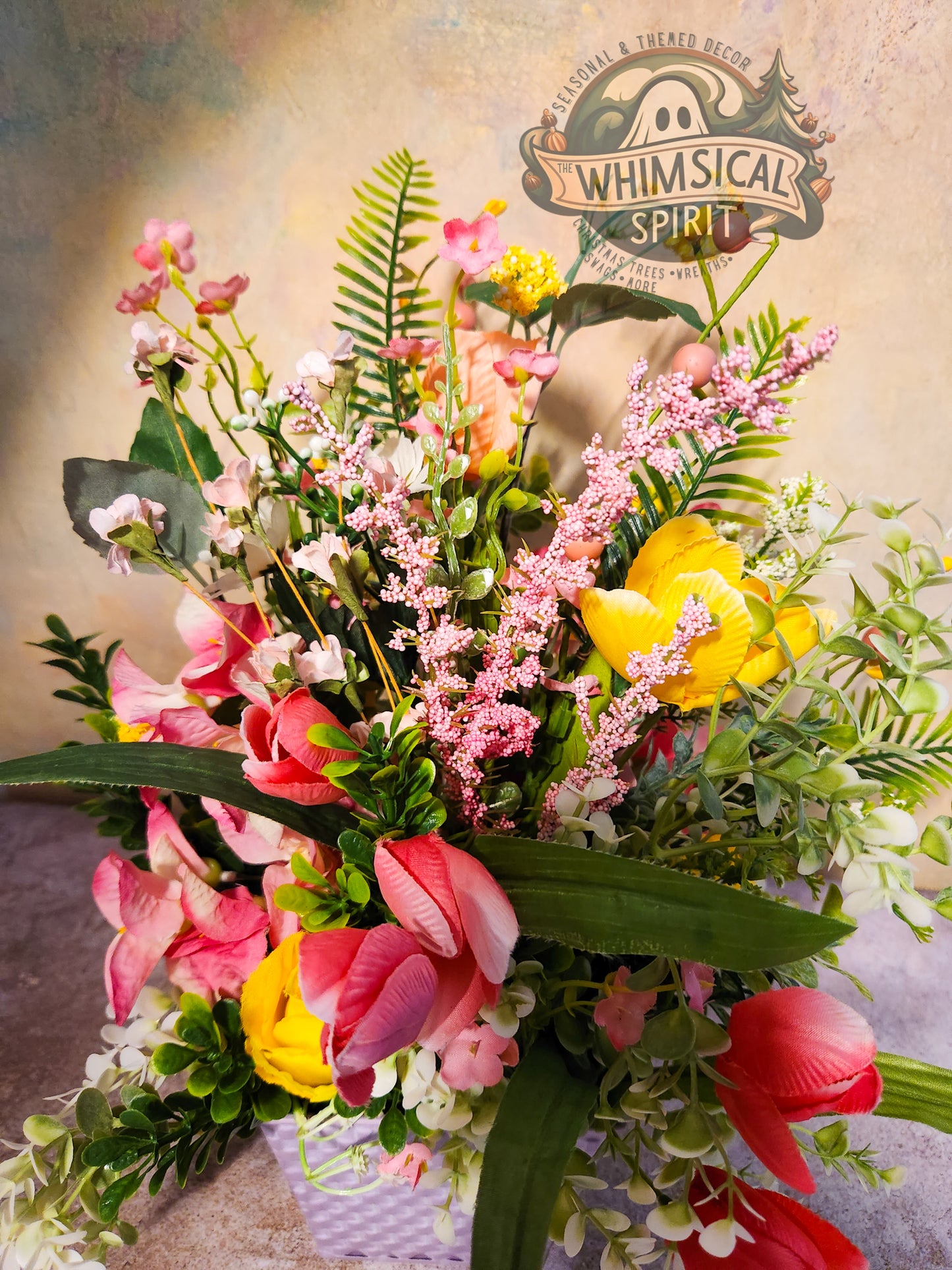 Bouquet of flowers with a 'Whimsical Spirit' logo in the background