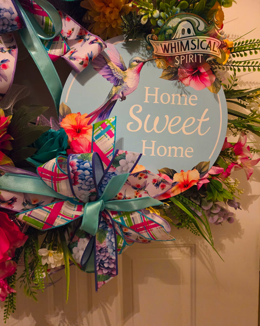 Decorative wreath with colorful ribbons and flowers, featuring a 'Home Sweet Home' sign.