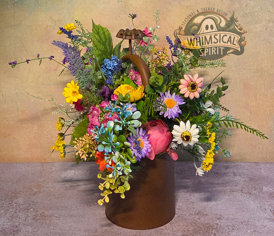 Colorful flower arrangement in a brown vase with 'Whimsical Spirit' logo in the background.