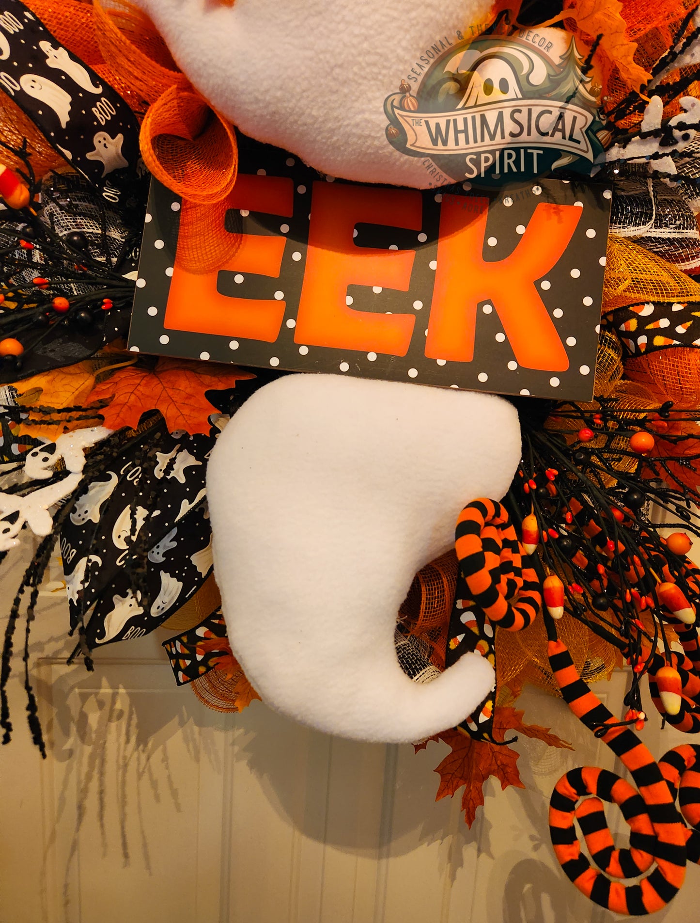 Halloween themed wreath with halloween decor and the word eek showing