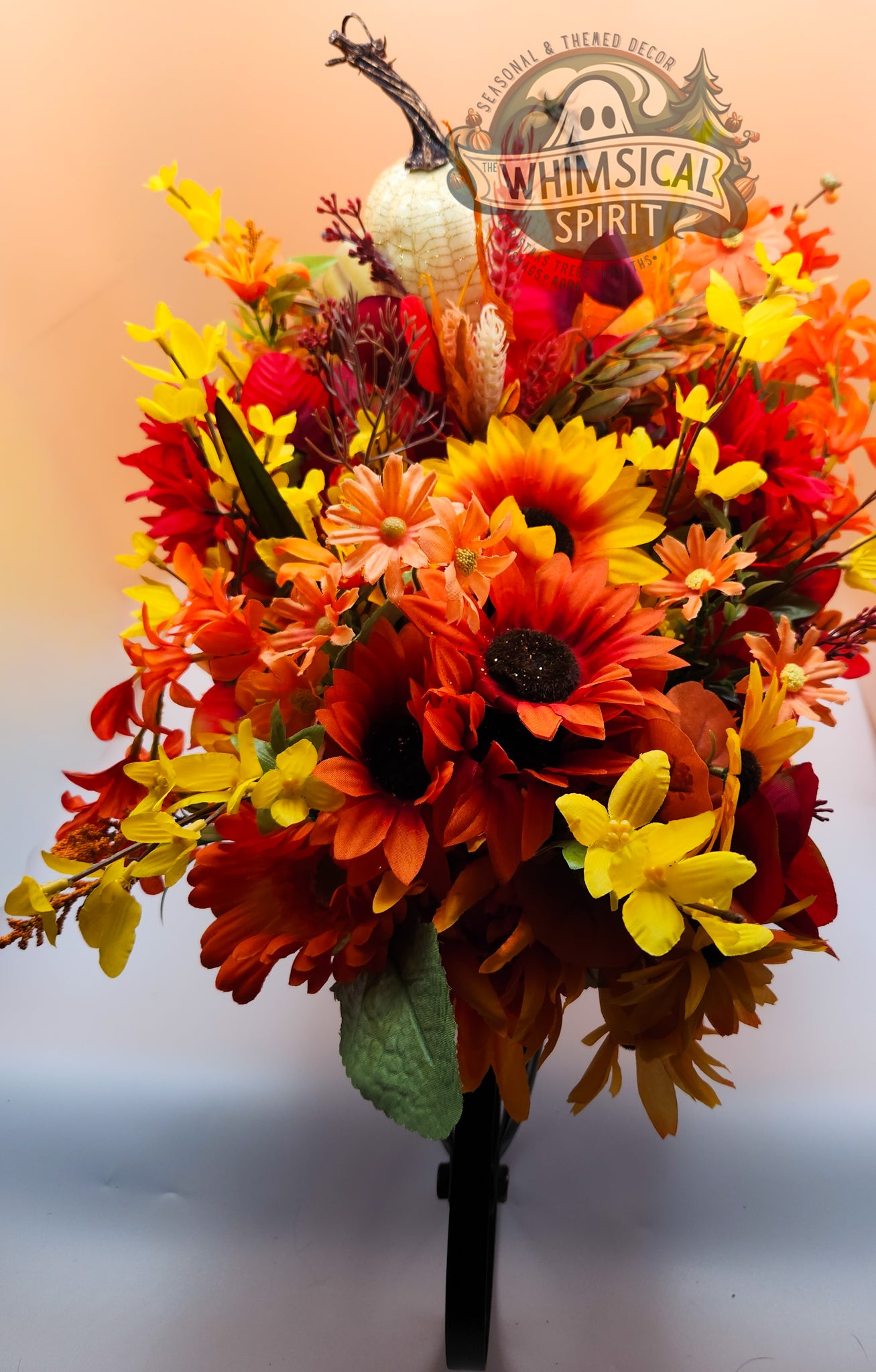 Autumn-themed floral arrangement with pumpkins and a 'Whimsical Spirit' logo.