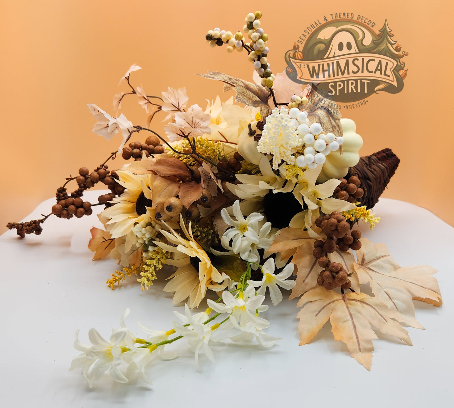 Rustic Grace cornucopia with cream florals, natural foliage, and earthy accents in a woven horn, blending neutral elegance with seasonal charm