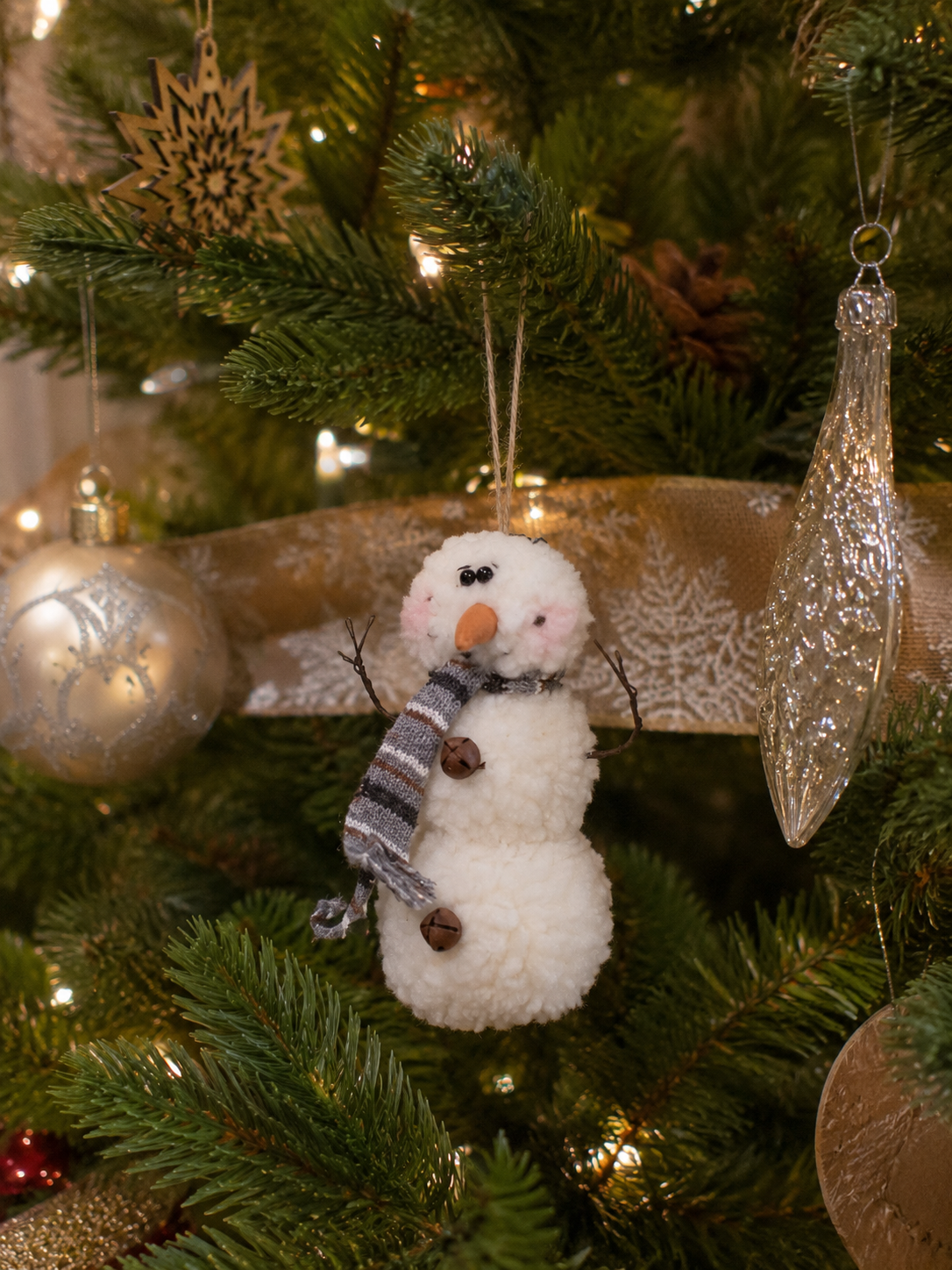 Snowman Christmas ornament displayed on a decorated holiday tree, perfect for curated ornaments, festive tree accents, and whimsical Christmas decor.