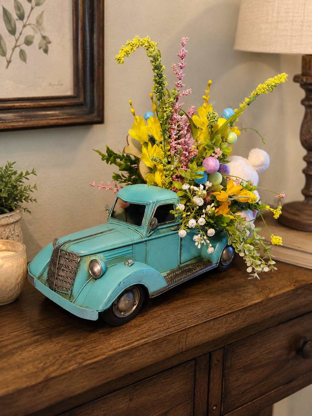 Spring Easter floral arrangement in a turquoise vintage car container, styled with yellow flowers, pastel eggs, greenery, and cheerful seasonal decor.