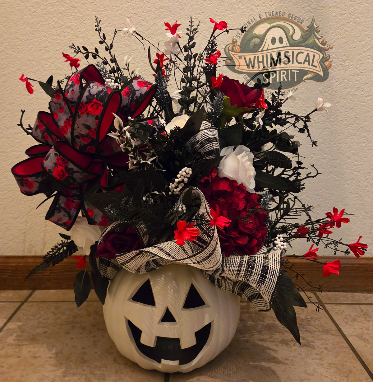 A Haunting in Crimson gothic Halloween floral centerpiece in a white jack-o’-lantern vessel.