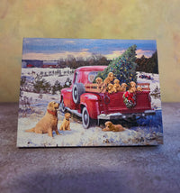 A Puppy Christmas light-up tabletop canvas featuring a red truck, Christmas tree, golden puppies, and snowy winter scene.