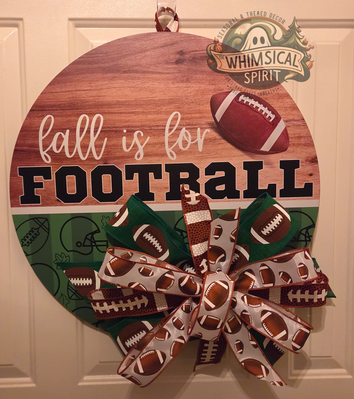 Round Fall Is for Football birch door hanger with woodgrain and green design, football graphic, and layered football-print bow.