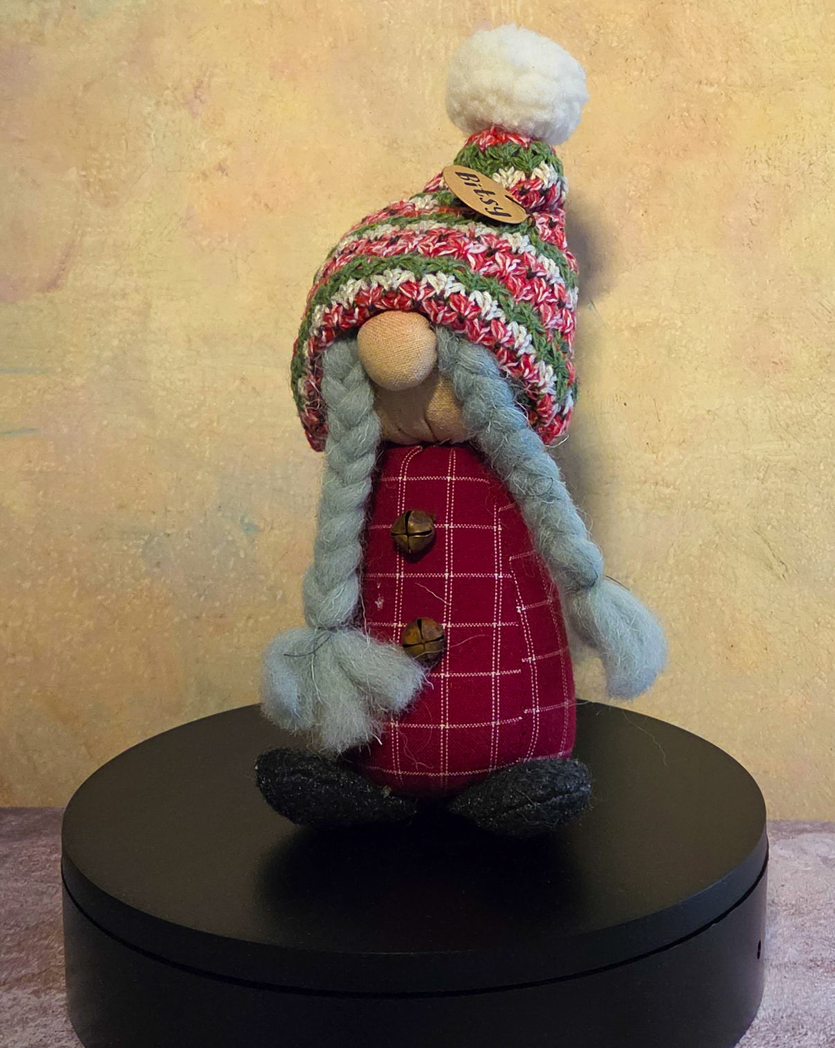 Bitsy the Gnome winter soft sculpture shelf sitter with braided gray hair, red plaid body, knit winter hat, pom-pom, button details, and name tag.
