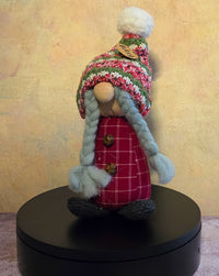 Bitsy the Gnome winter soft sculpture shelf sitter with braided gray hair, red plaid body, knit winter hat, pom-pom, button details, and name tag.