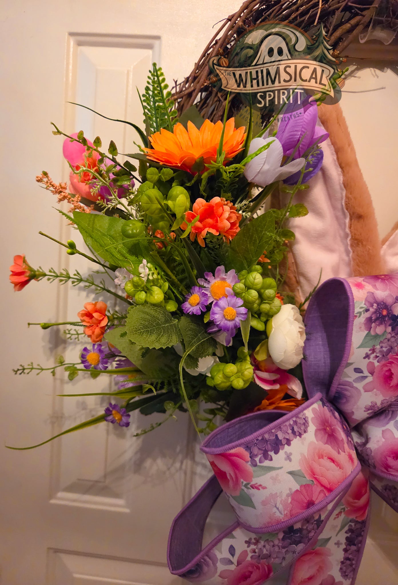 Floral arrangement with colorful flowers and a decorative basket on a white background