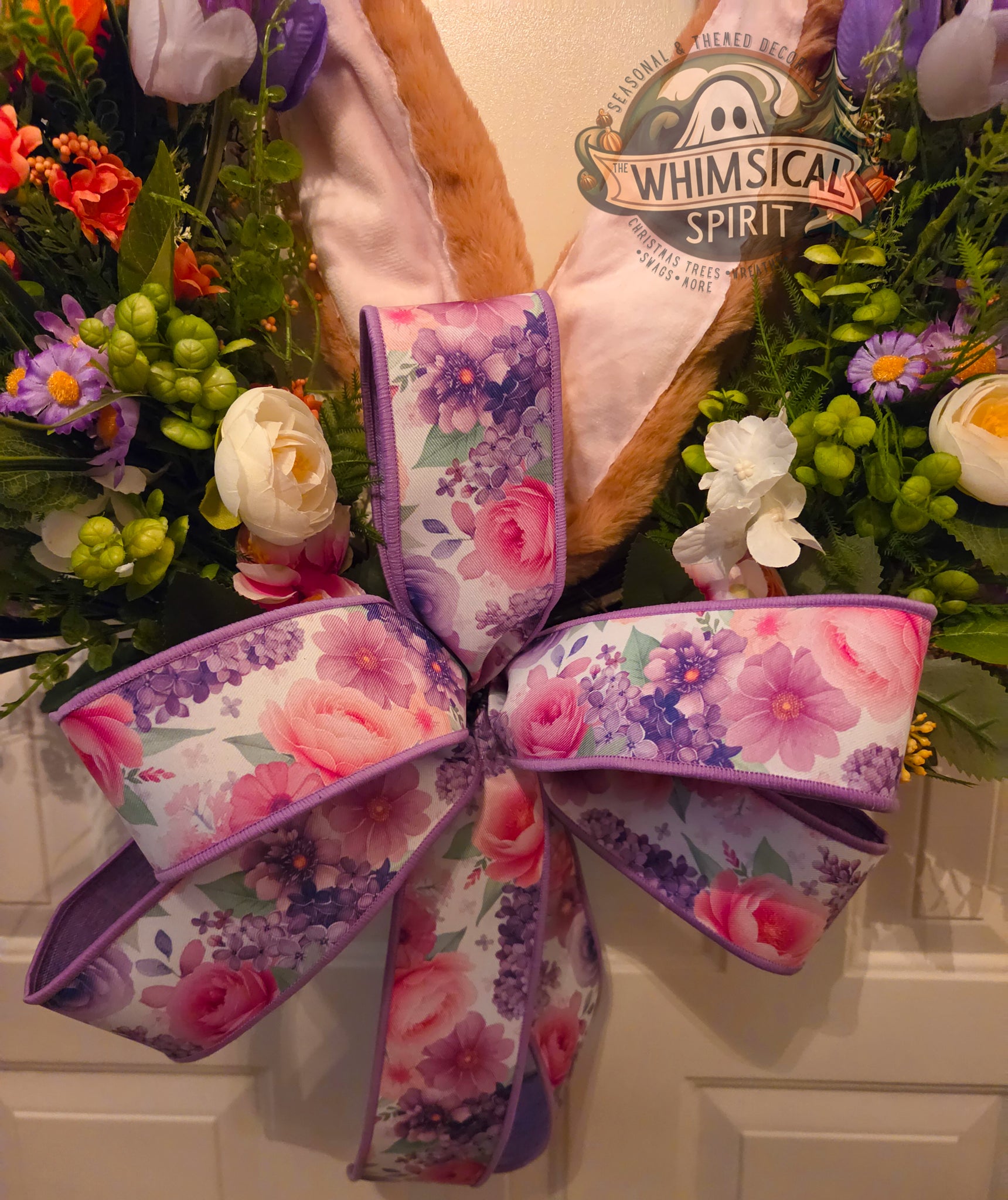 Floral ribbon bow with 'Whimsical Spirit' sign in the background