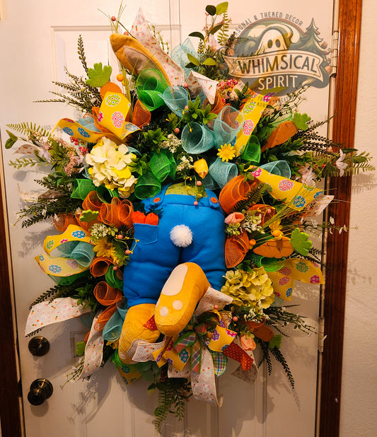Colorful wreath with cartoon character design on a door, featuring the brand 'Whimsical Spirit'.