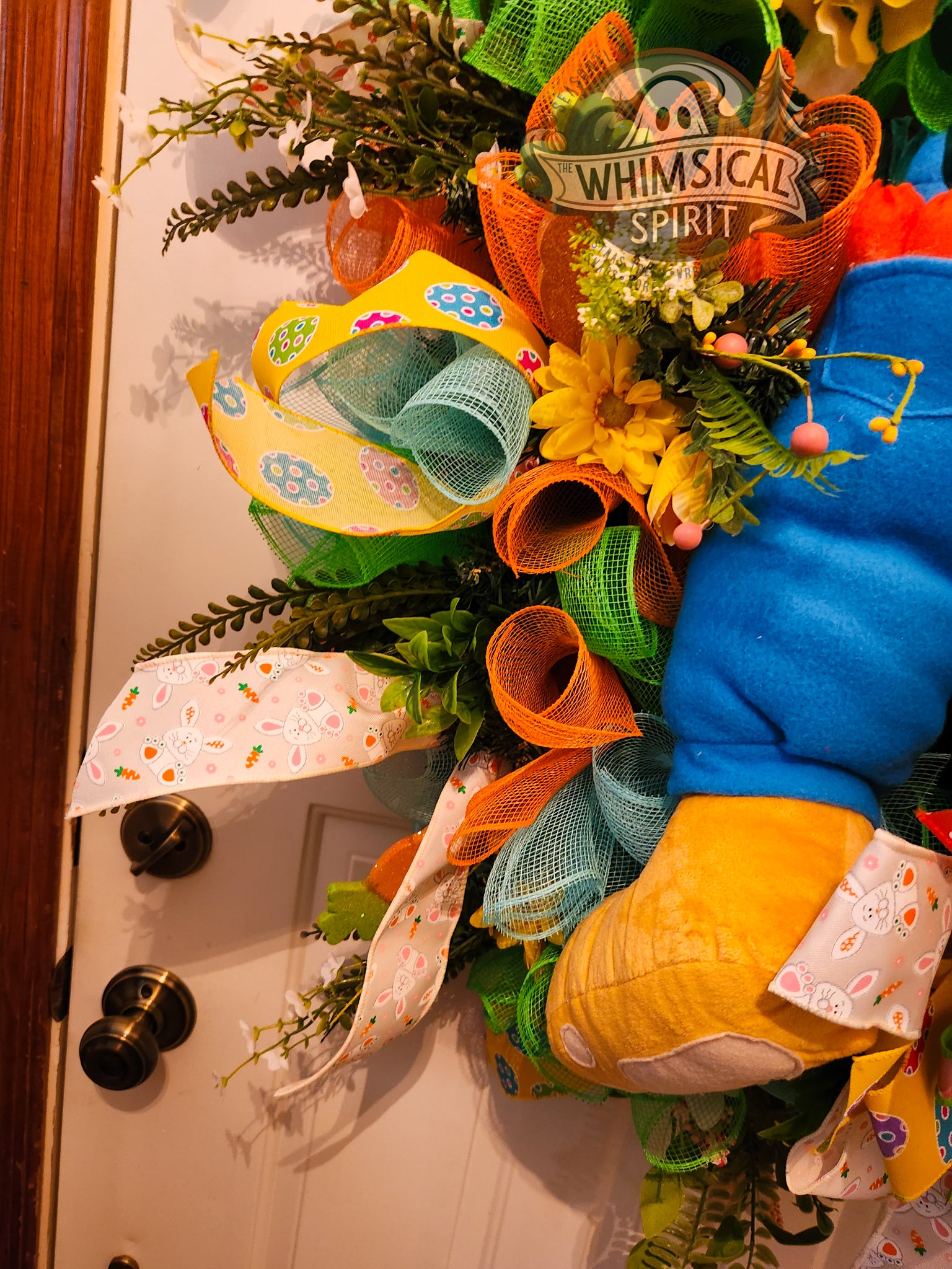 Colorful decorative wreath with various elements on a door