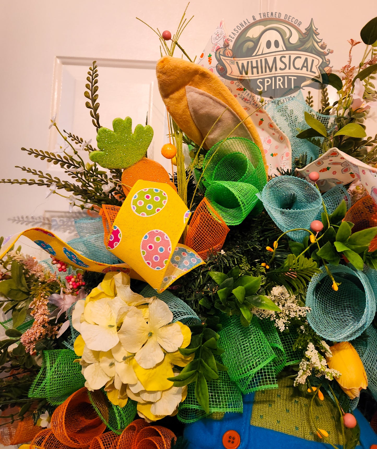 Colorful wreath with decorative elements and 'Whimsical Spirit' branding.
