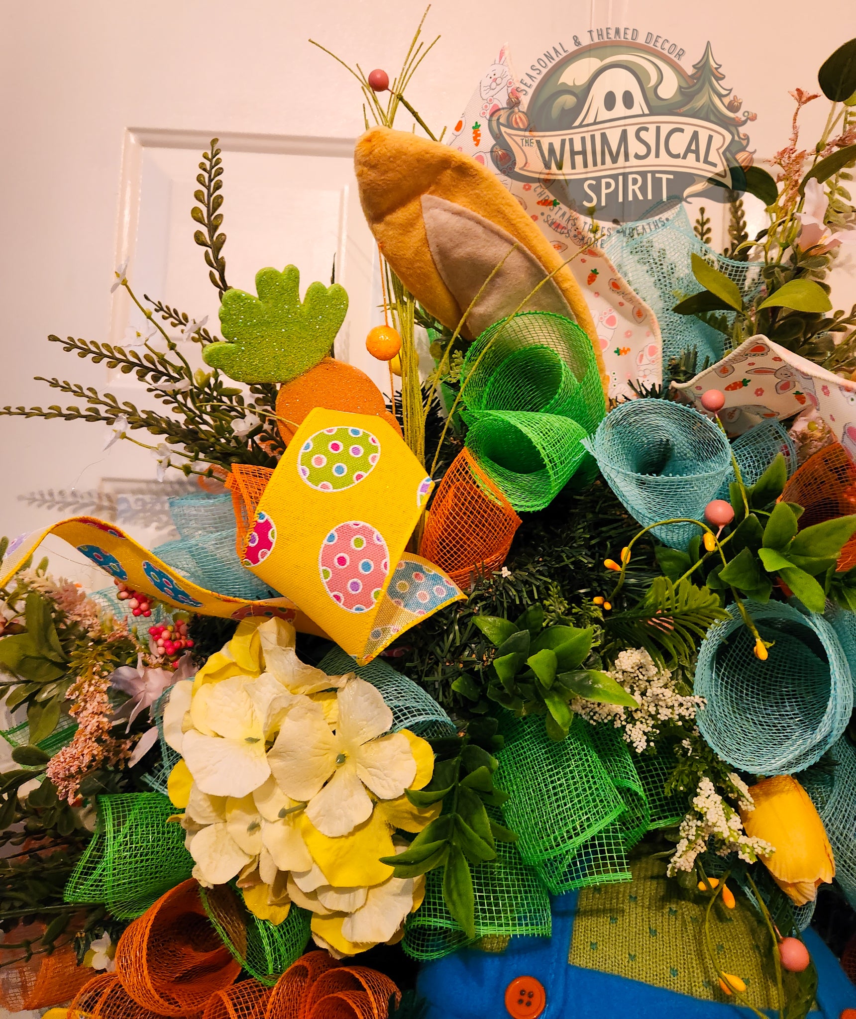 Colorful wreath with decorative elements and 'Whimsical Spirit' branding.