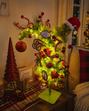 Handmade light-up Christmas tree with whimsical holiday accents and festive seasonal decor