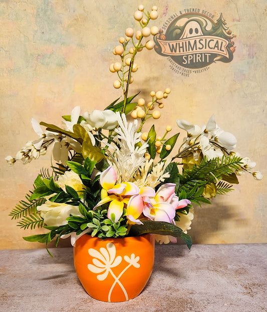 Floral arrangement in an orange pot with a decorative logo in the background