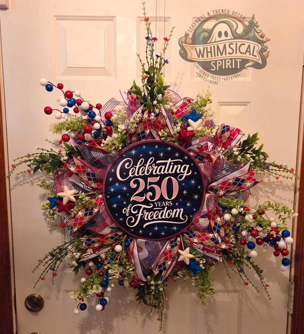 Decorative wreath with 'Celebrating 250 Years of Freedom' text on a door, branded 'Whimsical Spirit'.