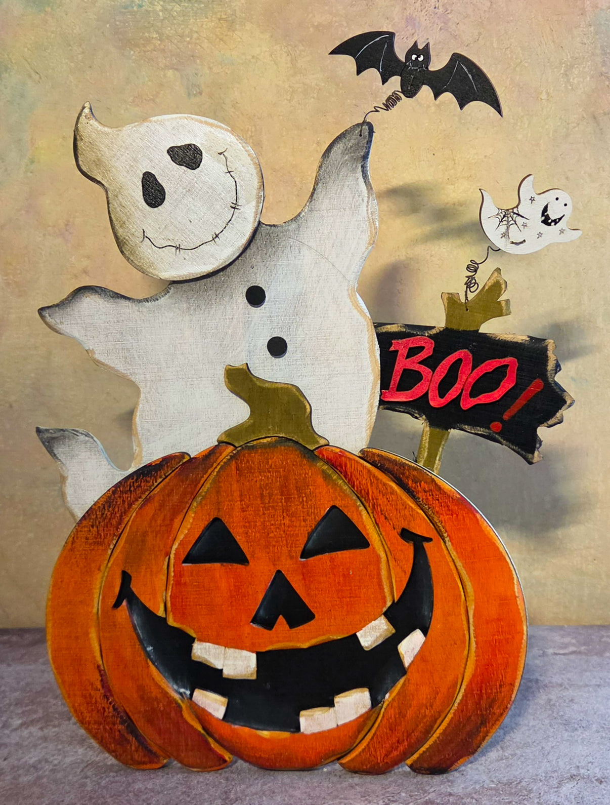 Front view of Ghost Pumpkin Scene plywood tabletop decor with a smiling ghost, large jack-o’-lantern, bat, smaller ghost, and BOO sign.