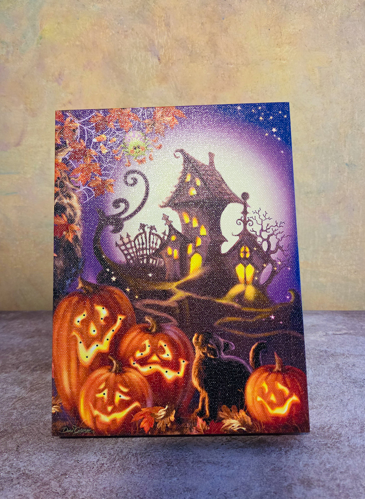 Haunted House light-up Halloween tabletop canvas featuring glowing jack-o’-lanterns, a crooked haunted house, black cat, and moonlit path.