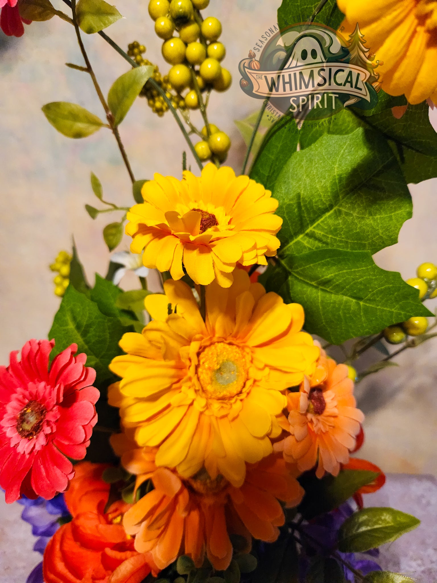 Colorful bouquet of flowers with a 'Whimsical Spirit' logo in the background