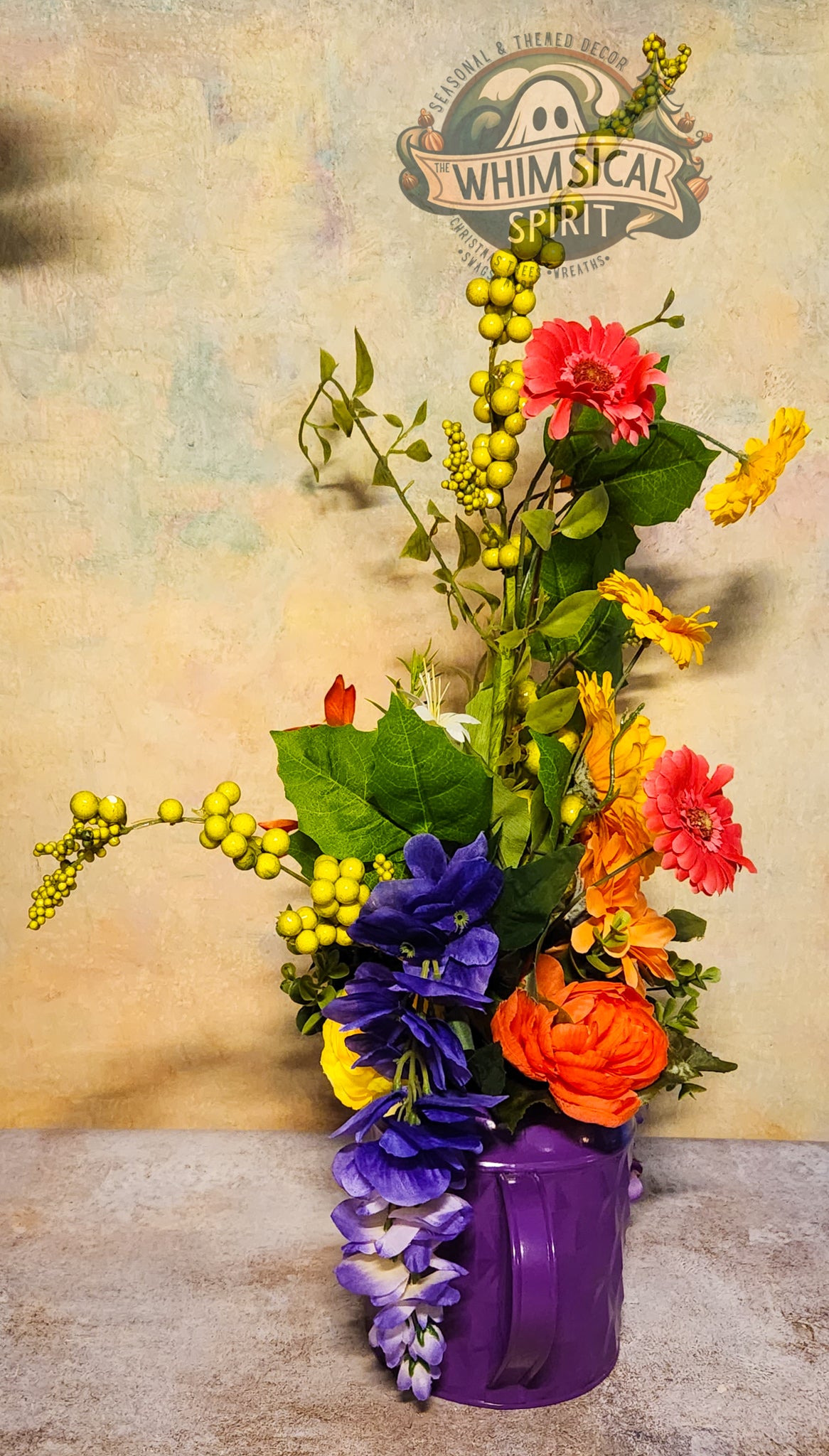 Colorful flower arrangement in a purple vase with 'Whimsical Spirit' logo in the background.