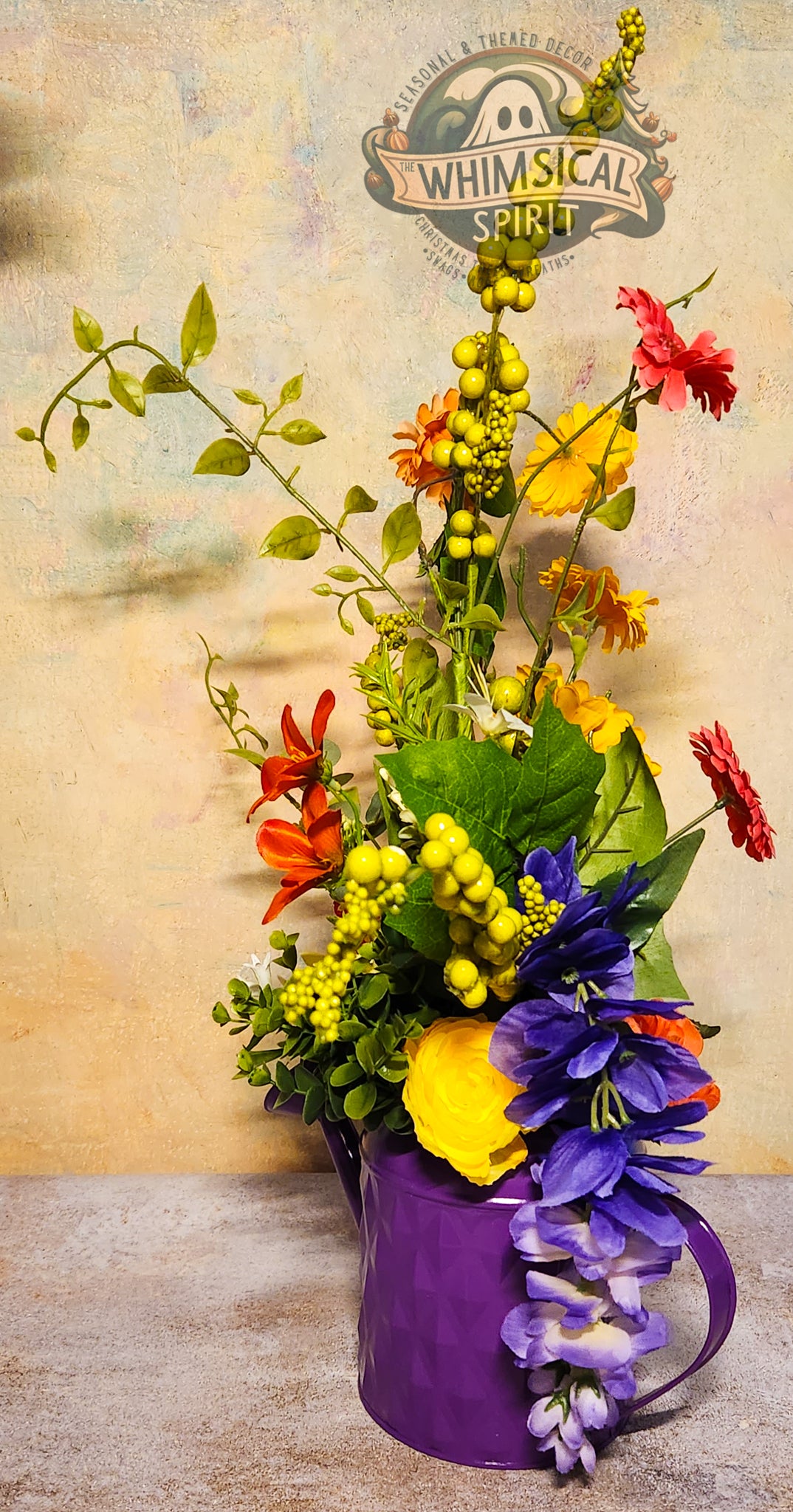 Colorful flower arrangement in a purple vase with 'Whimsical Spirit' logo in the background.