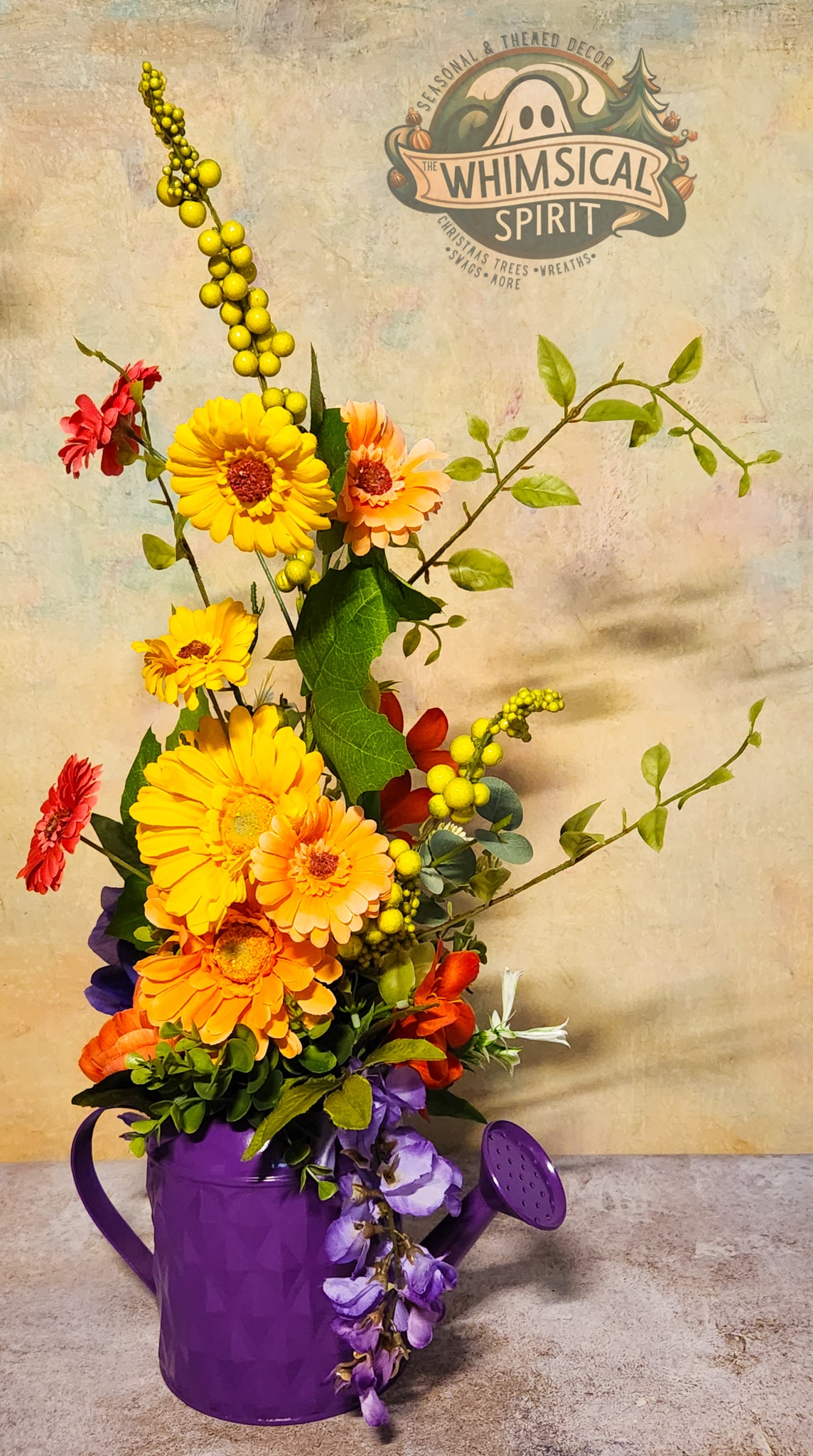 Colorful flower arrangement in a purple pitcher with 'Whimsical Spirit' branding in the background.