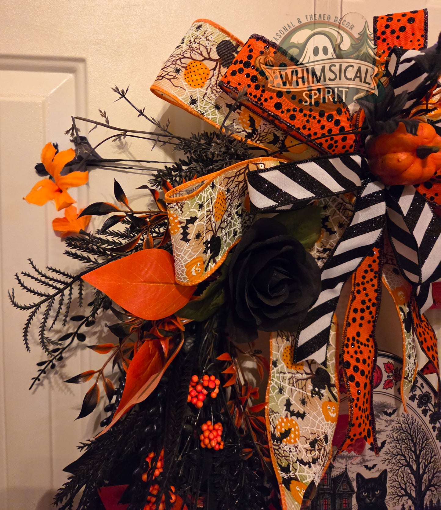 Halloween decorative bow with orange, black, and white ribbons on a plain background