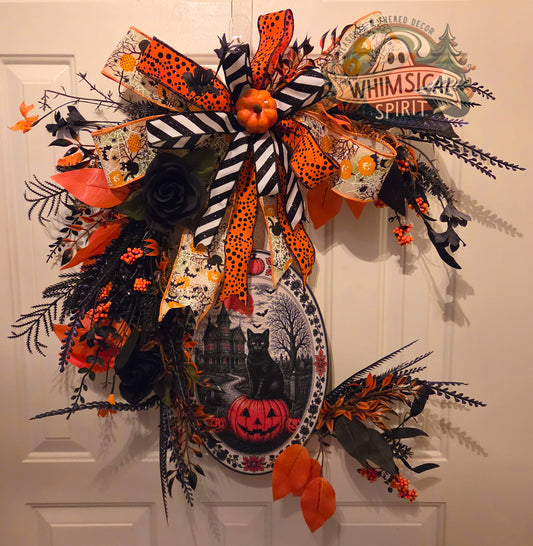 Halloween-themed decorative bow with pumpkins, ghosts, and other festive elements on a white door.