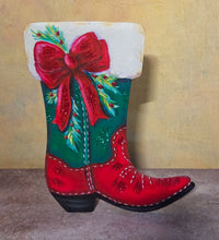 Front view of the Evergreen Bow Boot with a green upper, red foot, oversized red bow, evergreen sprigs, and white stitched accents.