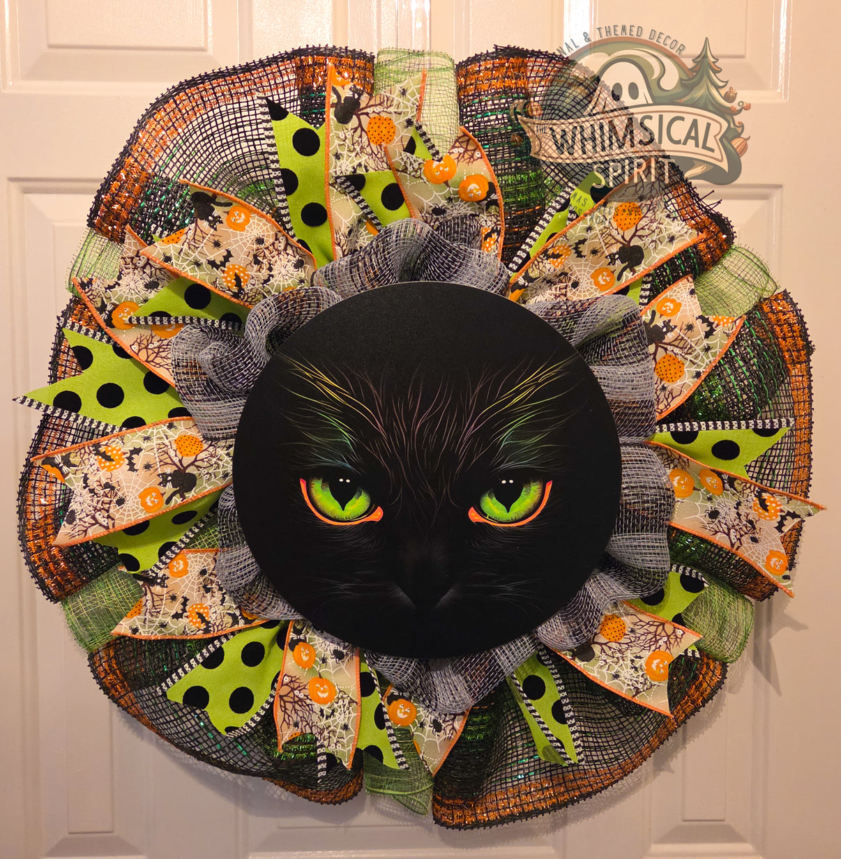 Nine Lives After Midnight black cat Halloween mesh wreath with green eyes, lime polka dots, spiders, and pumpkin ribbons.