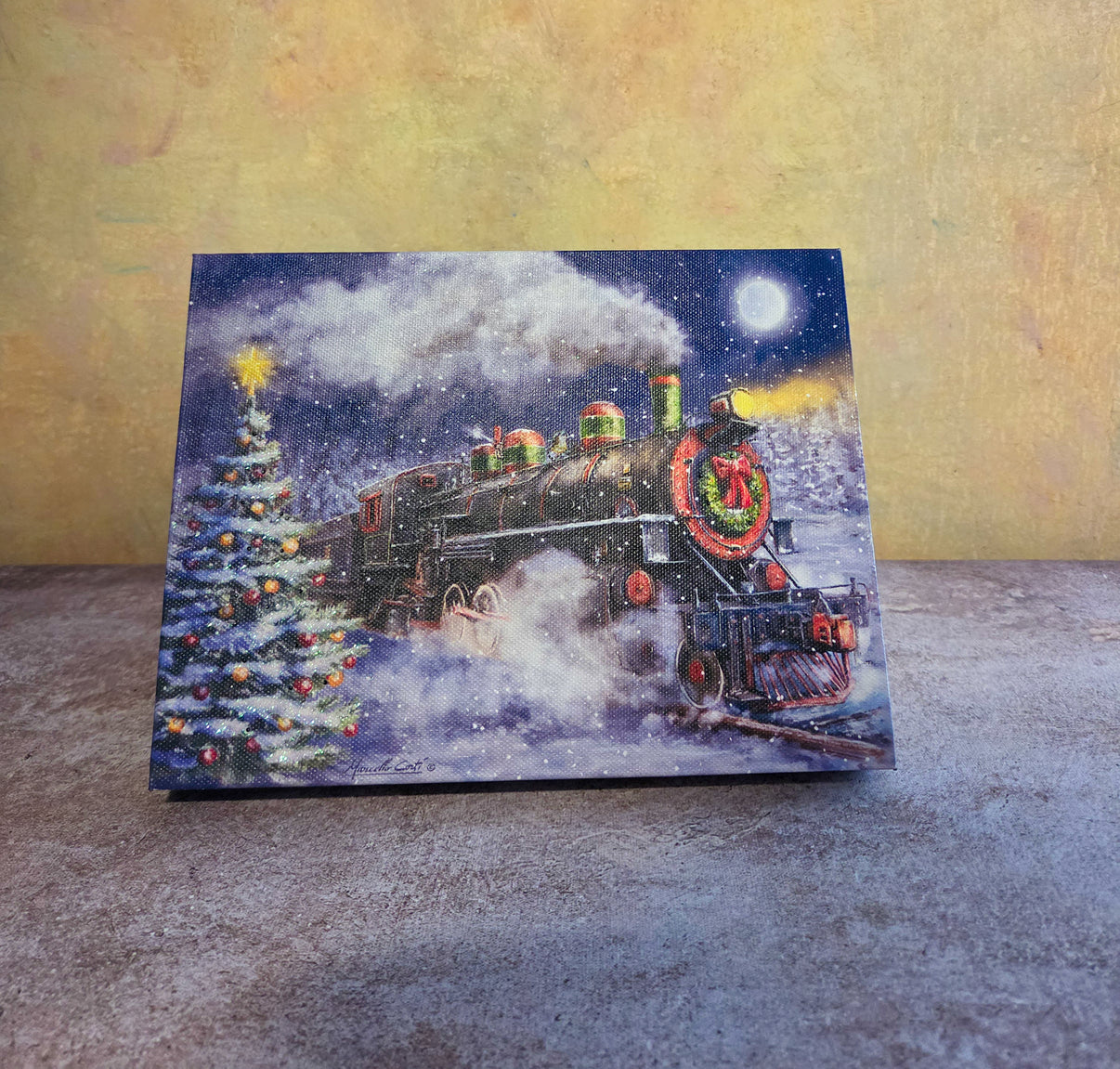 North Pole Express light-up Christmas tabletop canvas featuring a holiday train, decorated Christmas tree, snowy night sky, moon, and winter scene.