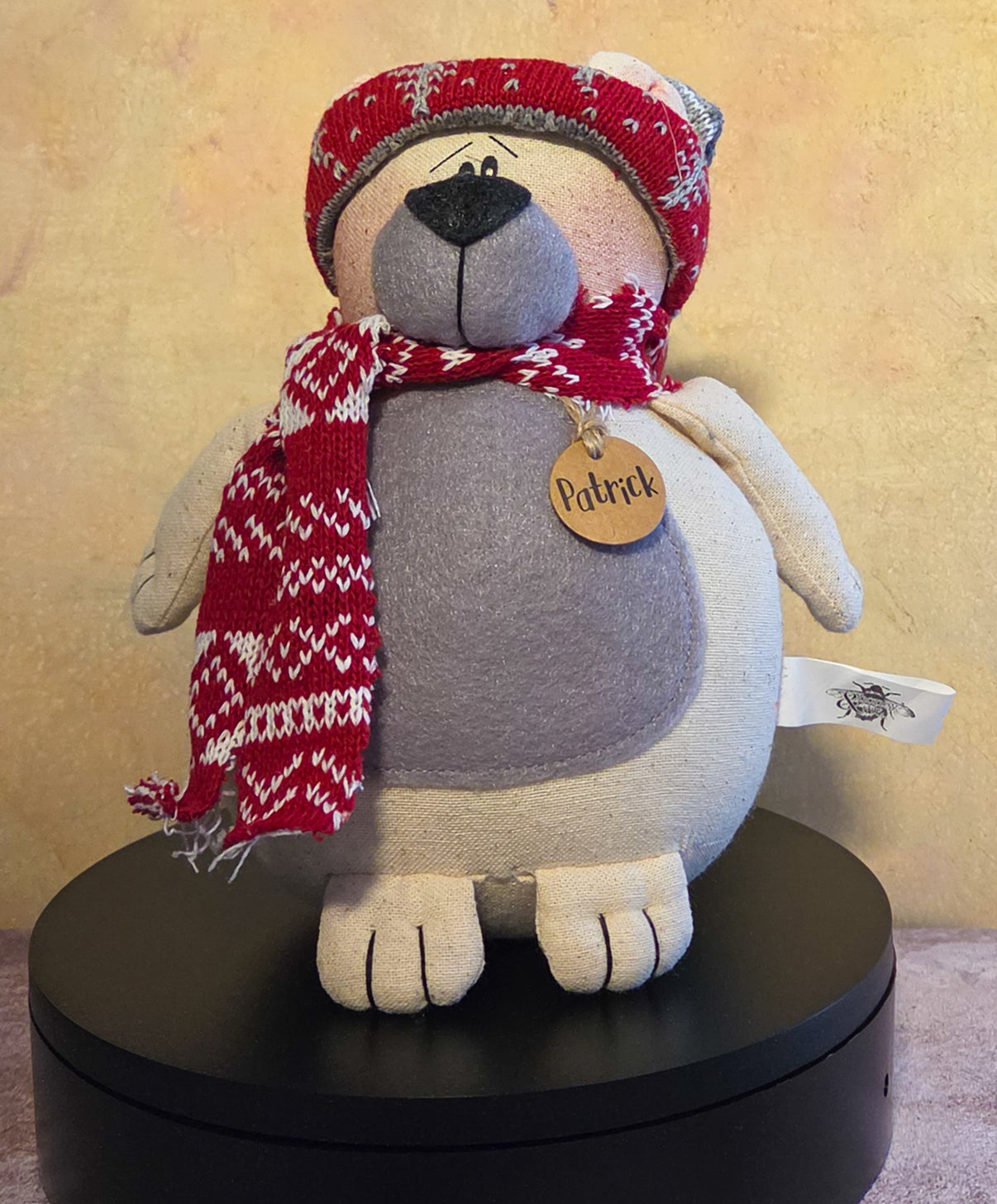Patrick the Polar Bear winter soft sculpture shelf sitter with red knit hat, matching scarf, gray belly, name tag, and cozy polar bear details.