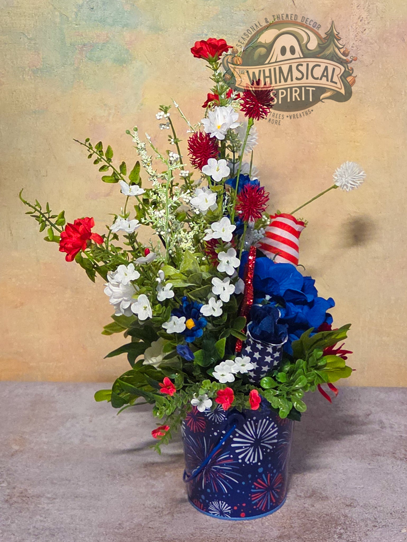 Bouquet of flowers with patriotic colors in a decorative vase, featuring the 'Whimsical Spirit' brand.