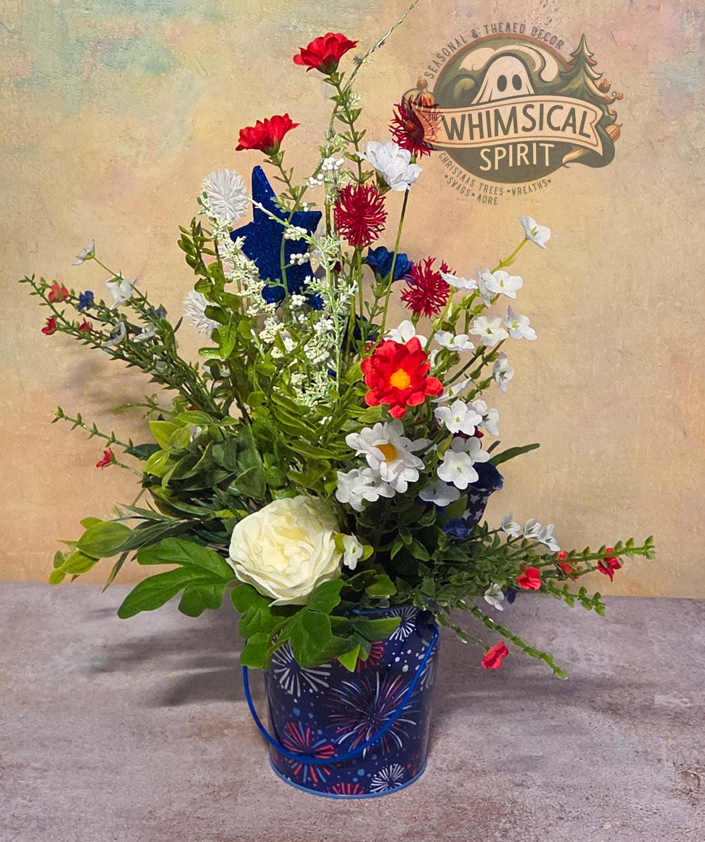 Floral arrangement in a blue vase with 'Whimsical Spirit' branding in the background.