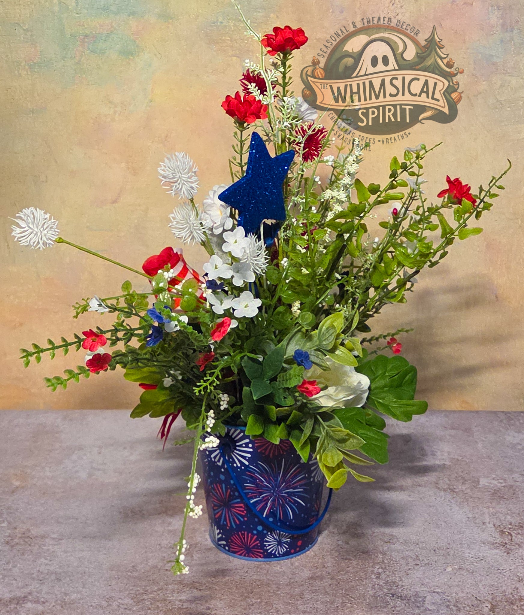 Floral arrangement with a blue star in a decorative pot on a textured surface, featuring the 'Whimsical Spirit' brand.