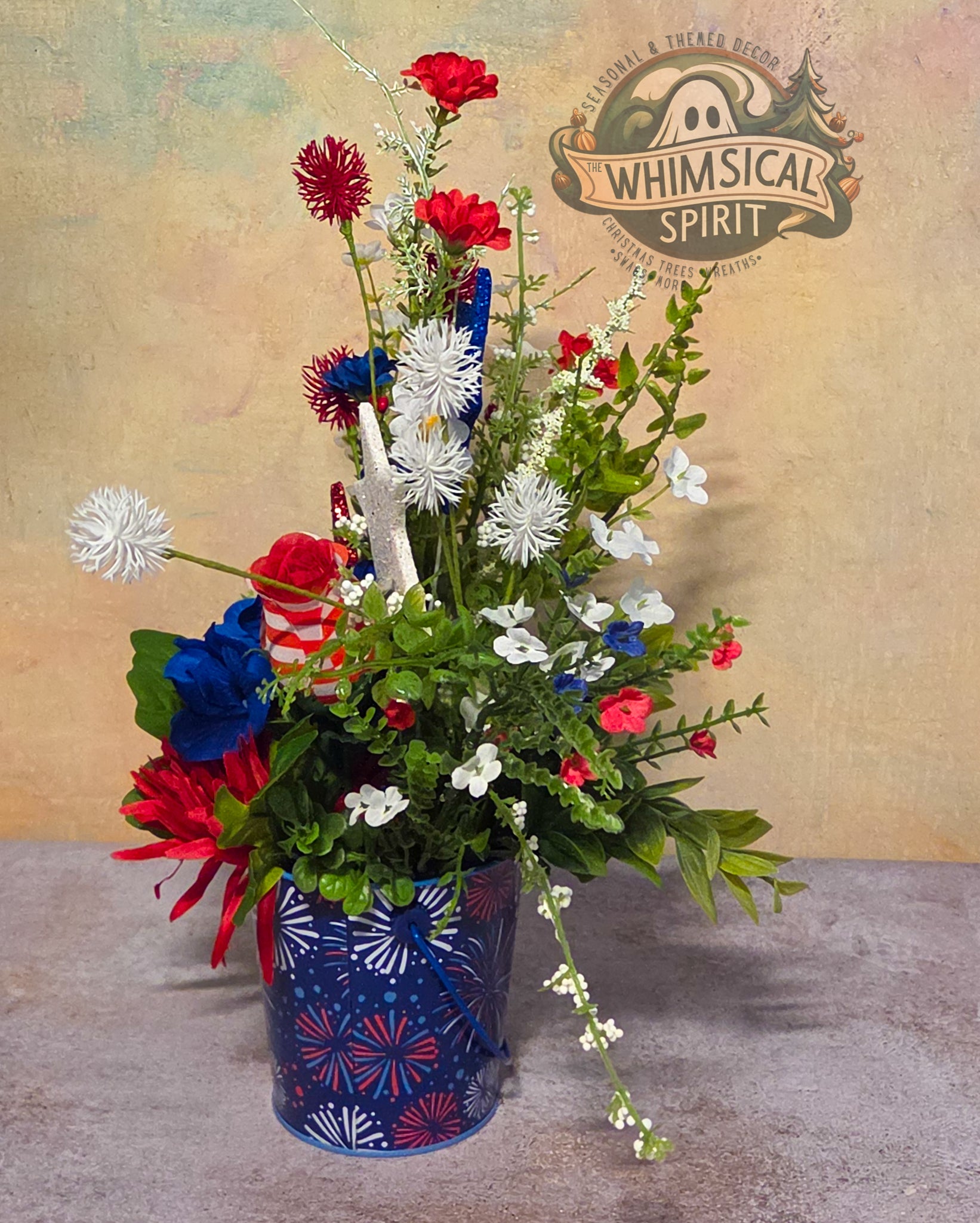 Colorful floral arrangement in a decorated pot with 'Whimsical Spirit' logo in the background.