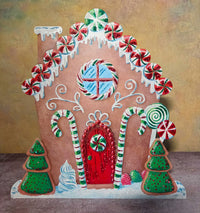 Peppermint Place gingerbread house Christmas metal art decorated with candy canes, peppermint swirls, gumdrops, snowy icing, and green cookie trees.