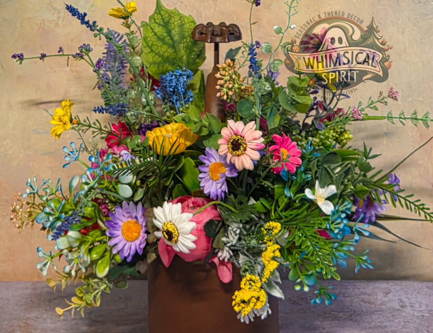 Colorful flower arrangement in a vase with 'Whimsical Spirit' branding in the background.