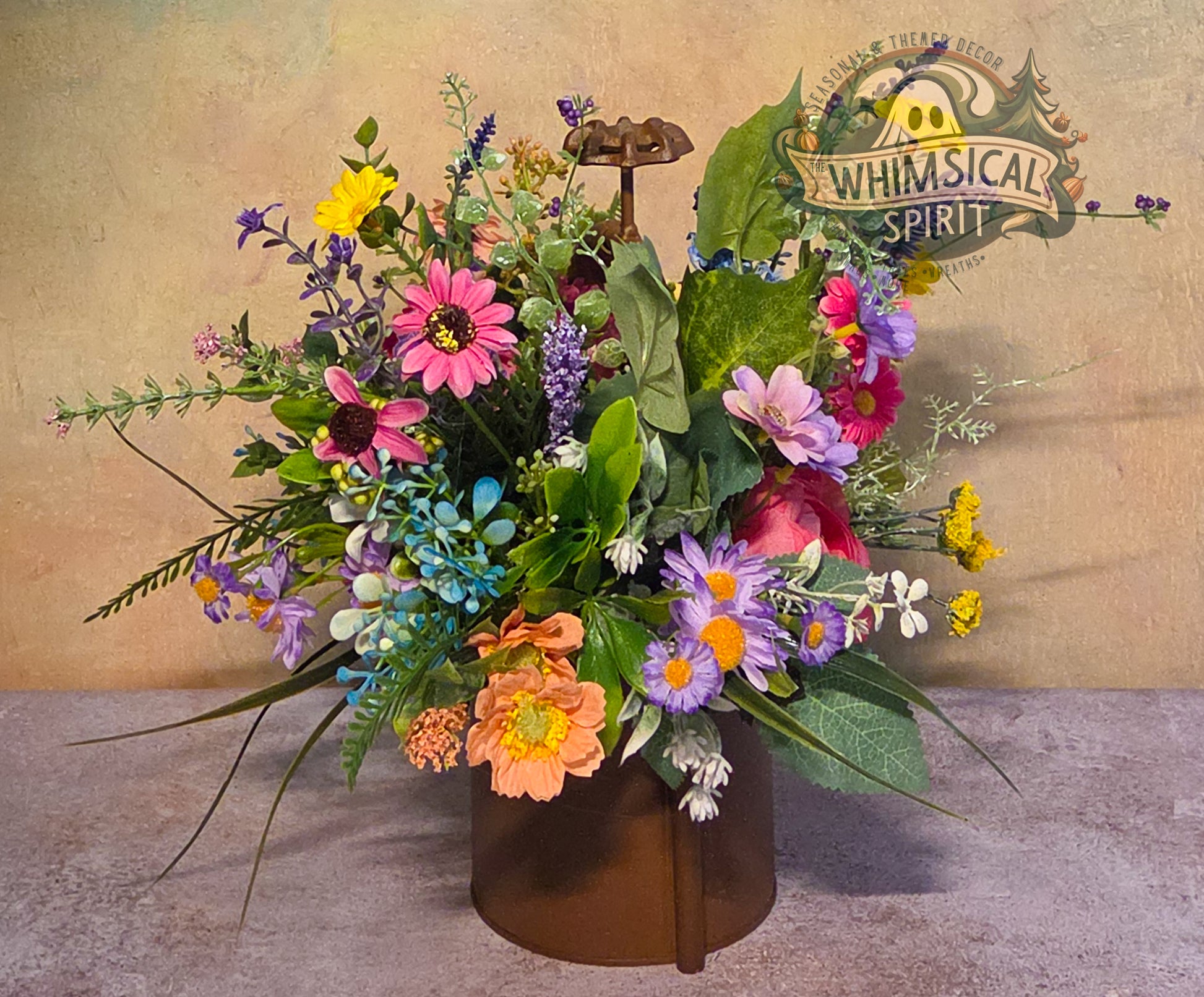 Colorful flower arrangement in a brown vase with 'Whimsical Spirit' logo in the background.