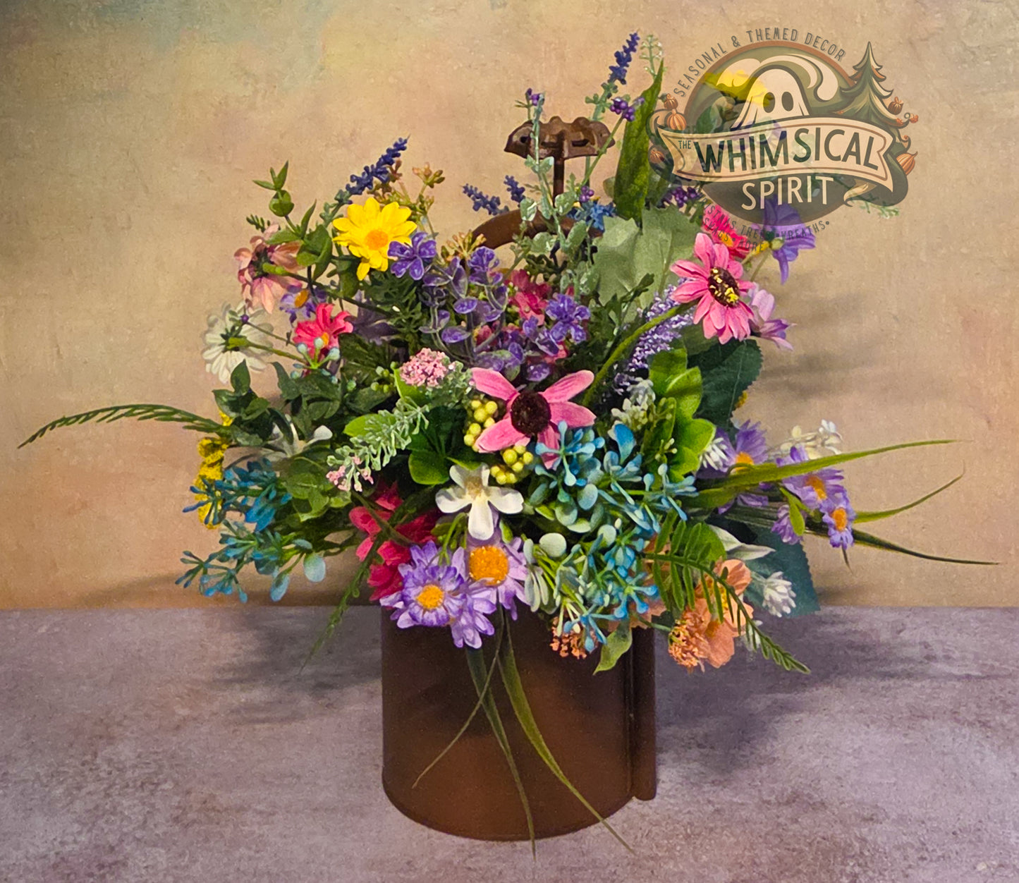 Colorful bouquet of flowers in a brown vase with 'Whimsical Spirit' logo in the background.
