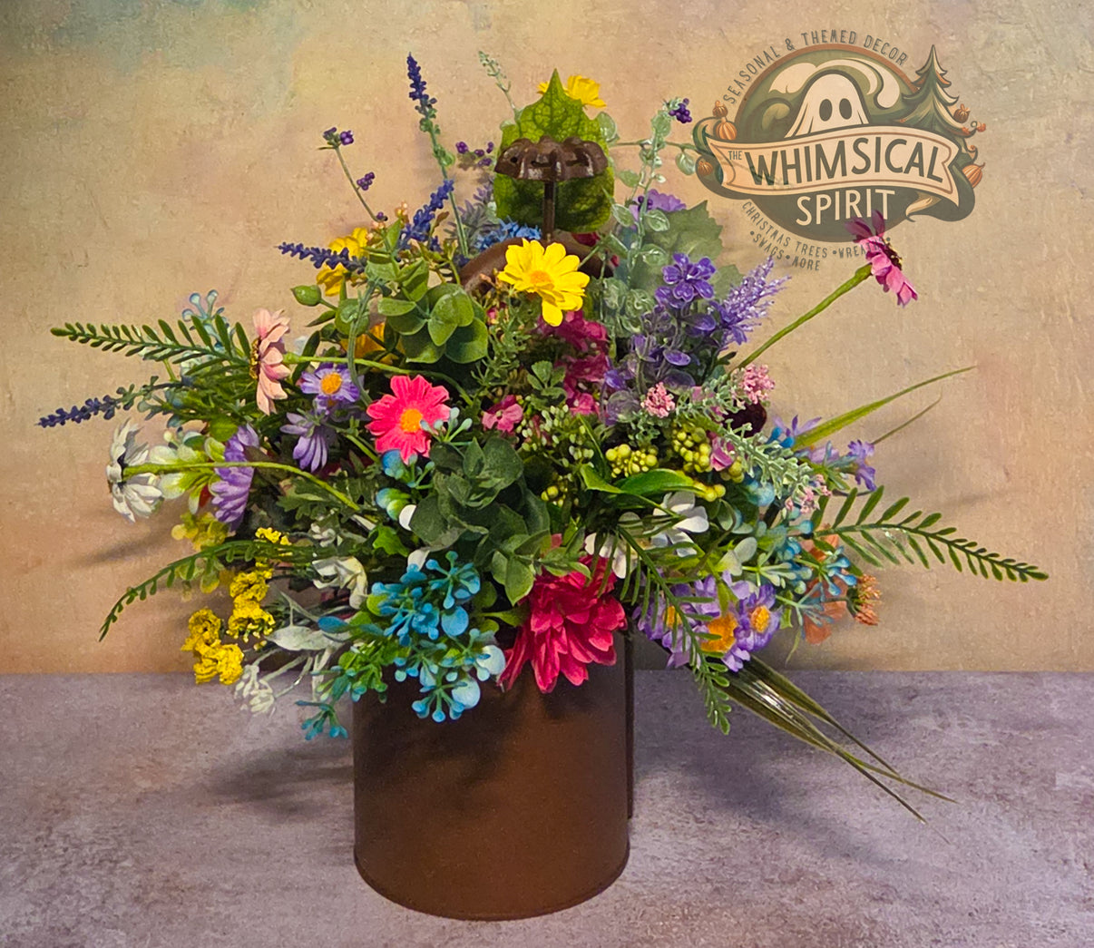 Colorful flower arrangement in a brown vase with 'Whimsical Spirit' branding in the background.