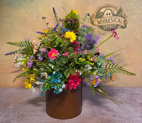 Colorful flower arrangement in a brown vase with 'Whimsical Spirit' branding in the background.