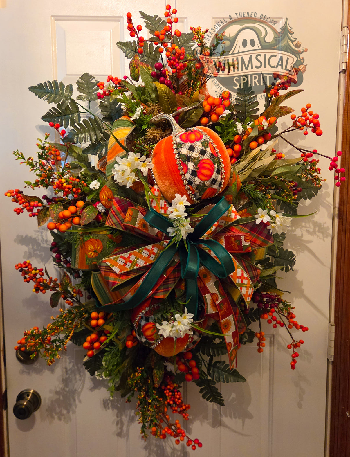 Pumpkin Patch Grandeur XXL fall door swag with decorative pumpkins, orange and red berries, white flowers, greenery, and layered plaid ribbons.